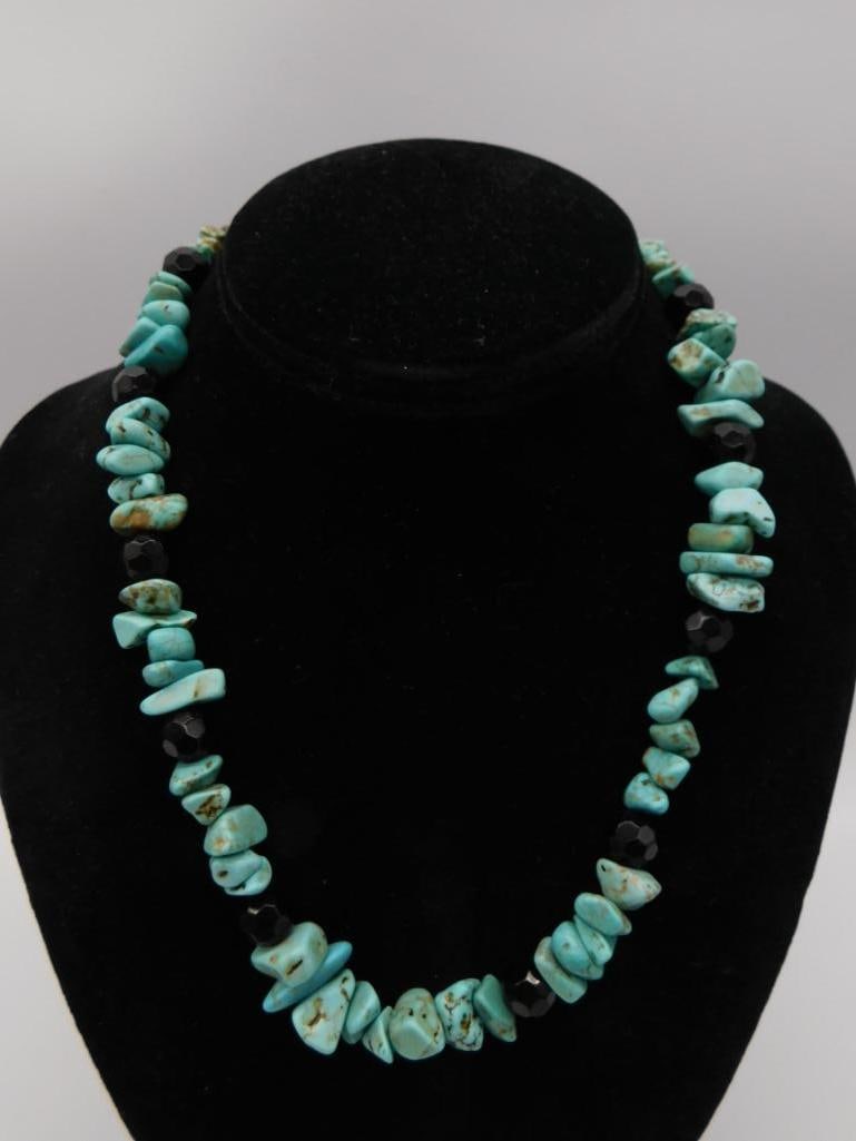Turquoise and Black Bead Chip Necklace: A beaded necklace of chunky natural turquoise nugget chips alternating with faceted black beads. Approximately 17-18 inches.