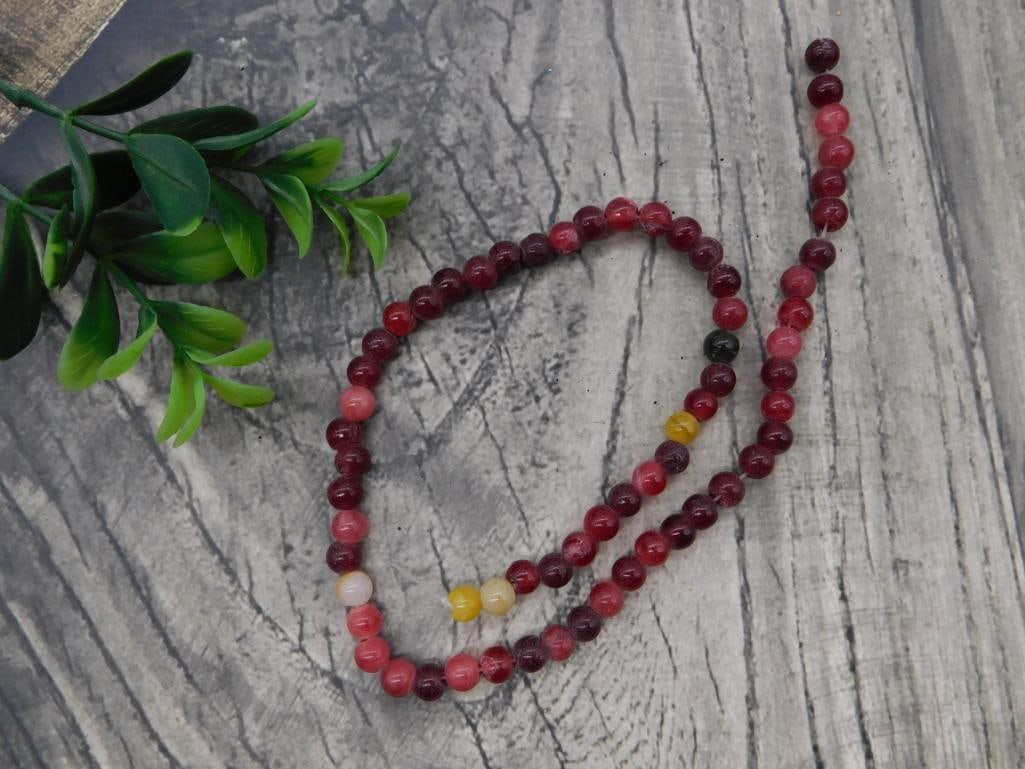 Rhodonite and Mookaite Jasper Beaded Necklace: Long strand necklace of round dark red, pink, and yellow rhodonite/jasper beads.
