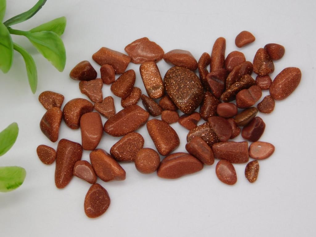 Tumbled Goldstone Stone Lot: Collection of tumbled polished goldstone (glittery brown glass) pebbles of varying shapes and sizes.