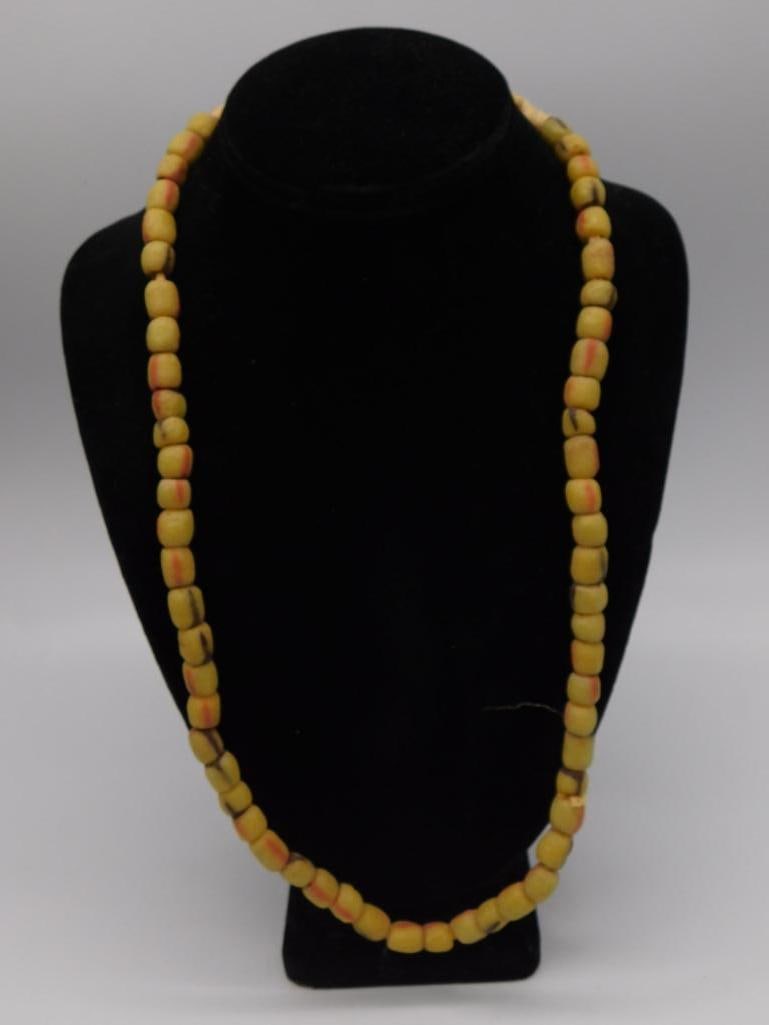 Yellow African Trade Bead Necklace: Long strand necklace of yellow glass trade beads with orange striping.
