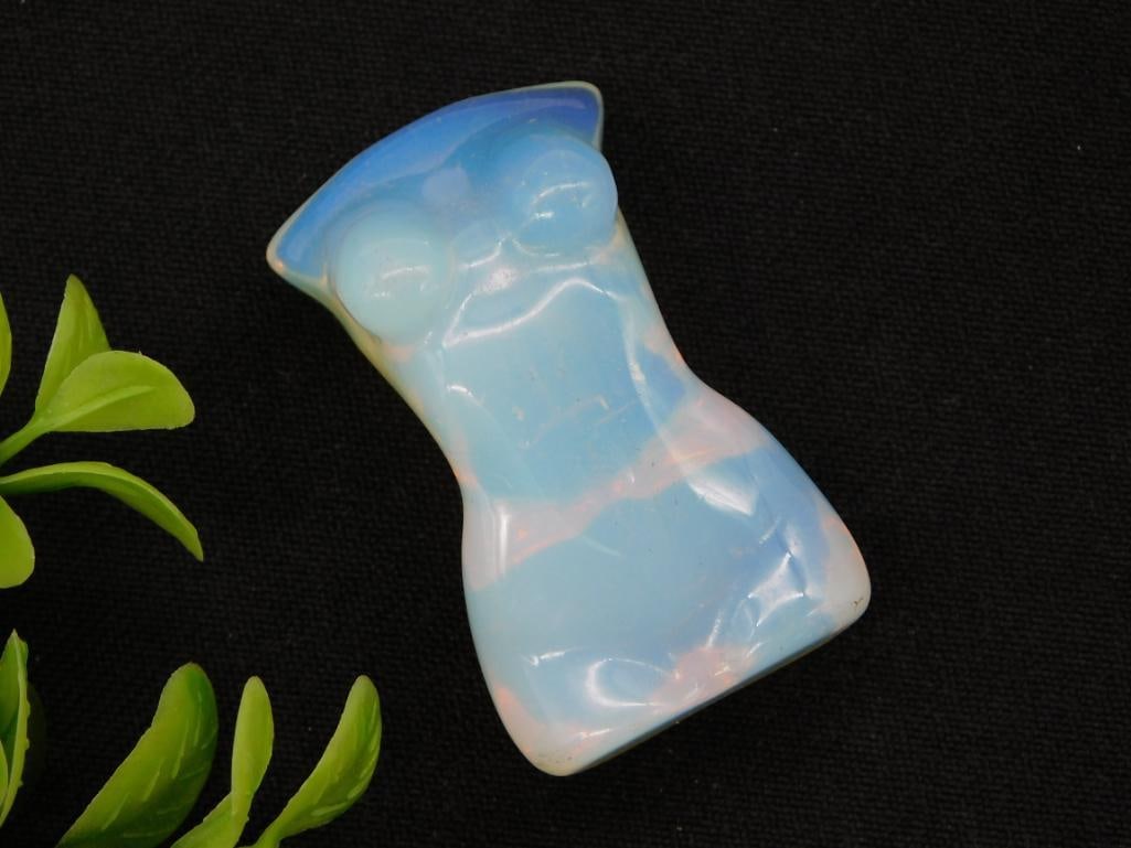 Opalite Carved Crystal Figurine: Opalite glass carved figural specimen with blue and white iridescent glow.