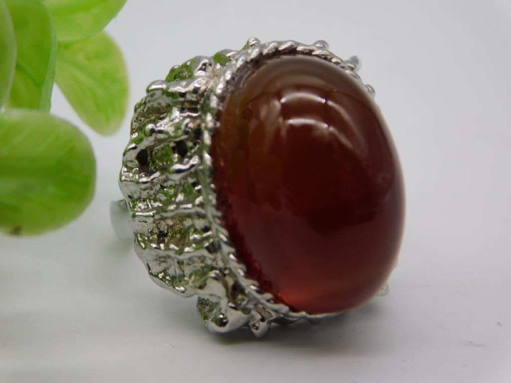 Carnelian Cabochon Statement Ring: Large oval carnelian cabochon ring set in ornate silver-tone textured mounting.