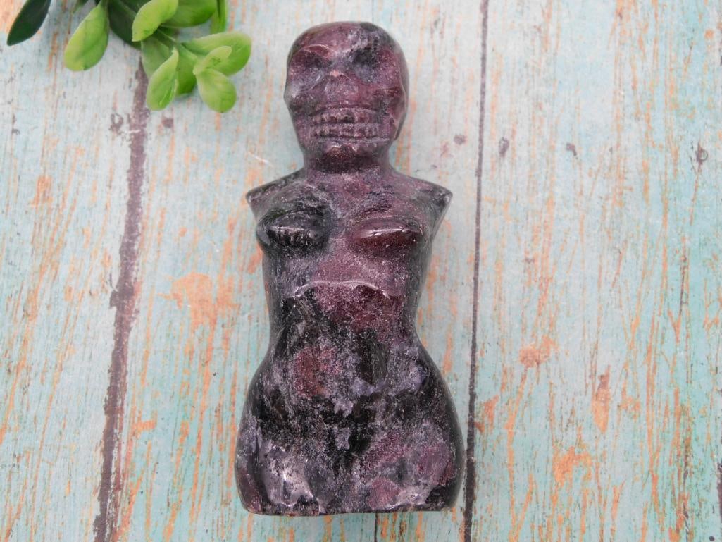 Carved Stone Skeleton Figure and Vintage Toy Car Bank Lot: This lot pairs a carved purple and black stone figure with a skull-like face with a die-cast 1946 Chevrolet Sedan Delivery Street Rod bank still in its original Pro Hardware box. Please review photos