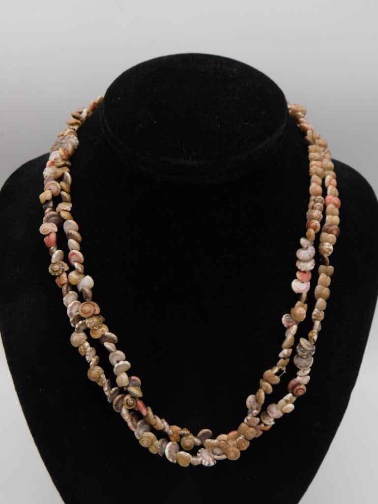 Multi-Strand Shell Necklace Natural Seashell Jewelry: A three-strand necklace made entirely of small natural spiral shells in cream tan and pink tones measuring approximately 17 inches long.