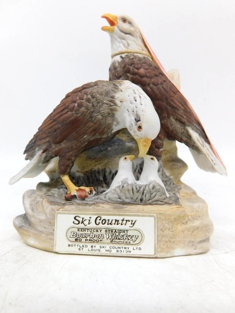 Ski Country Bald Eagle Family Miniature: A Ski Country miniature modeled as a pair of bald eagles tending two downy eaglets in a nest upon a rocky ledge. The feather work is admirable — russet backs, white heads, yellow bills — and the