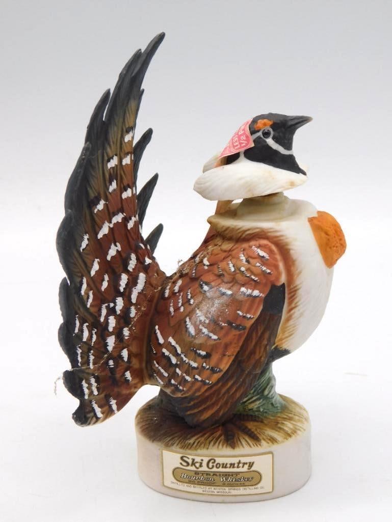 Ski Country Ruffed Grouse Miniature: A Ski Country Straight Bourbon Whiskey miniature sculpted as a ruffed grouse with his tail fanned wide, no small feat of the mold-maker's art at so small a scale. Less than 1/2 pint size,