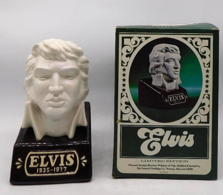 McCormick Elvis Presley 1935-1977: A McCormick limited edition decanter modeled as a portrait bust of Elvis Presley, head and shoulders in soft white bisque above a deep brown plinth lettered ELVIS 1935-1977. The sculptor caught the
