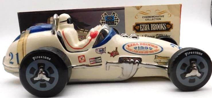 Ezra Brooks Indianapolis Race Car No. 21: An Ezra Brooks decanter modeled as an Indianapolis roadster, number 21, the driver at the wheel and Firestone tires beneath a chrome-bright body. Capital mold work, and the decals for Champion and the