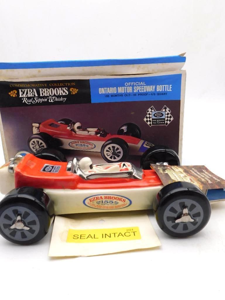 Ezra Brooks Ontario Motor Speedway No.: The official Ontario Motor Speedway bottle from Ezra Brooks, modeled as a racing car in orange and white with a helmeted driver at the wheel and the number 10 on the flank. Hand decorated with pure pl
