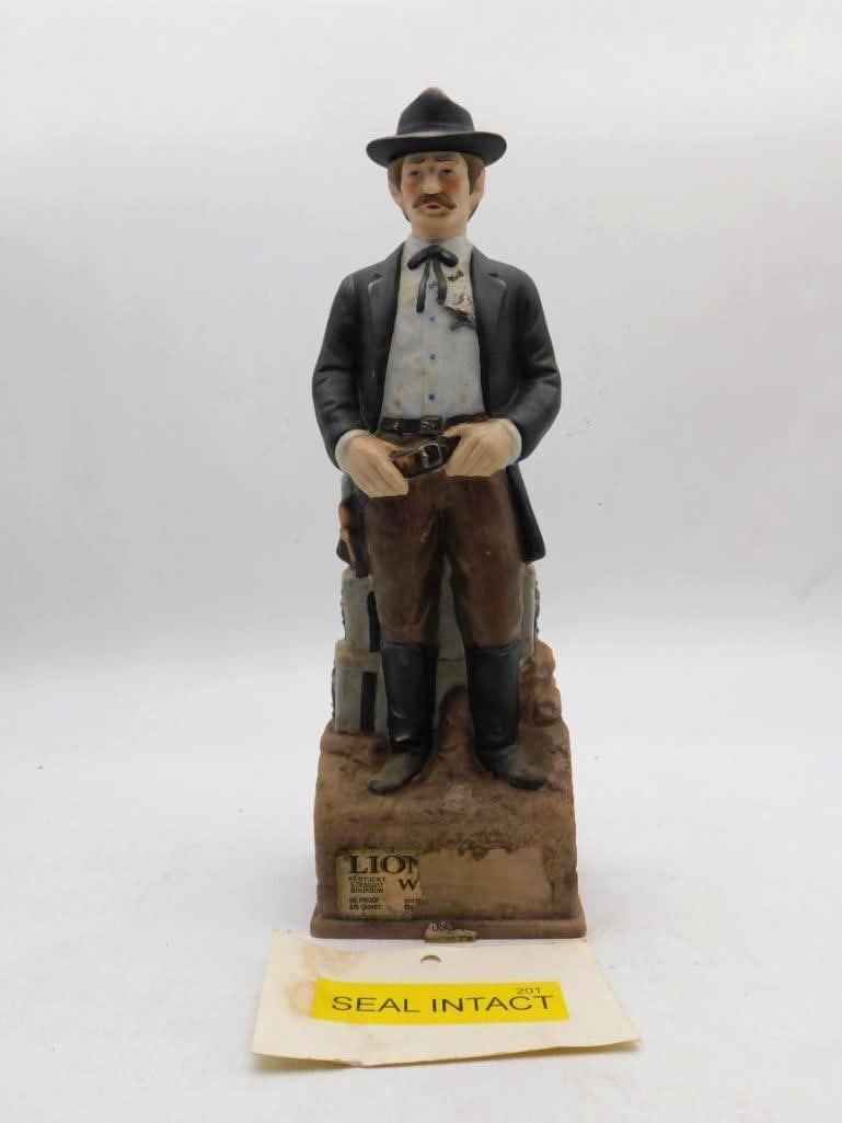 Lionstone Wells Fargo Man Old West: A dignified Lionstone decanter modeled as a Wells Fargo express man in frock coat and derby, standing beside strongboxes lettered Wells Fargo Company 1881. The front plaque gives the Lionstone
