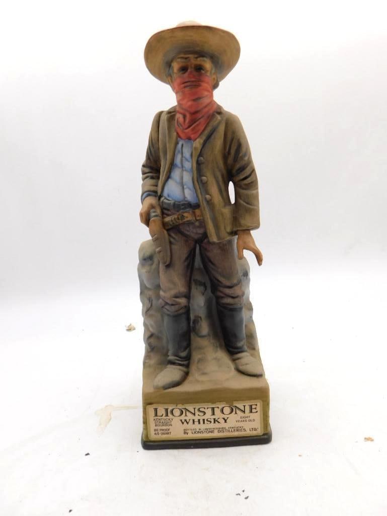 Lionstone Old West Highway Robber: A Lionstone Old West decanter modeled as a masked road agent, bandanna drawn over his face and one hand resting on the pistol at his belt. The painter worked the dusty coat and worn boots with a