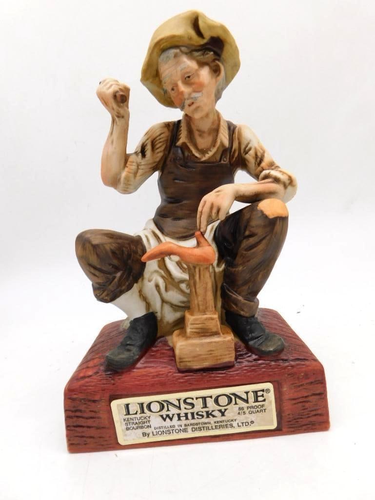 Lionstone Whiskey The Cobbler European: A Lionstone Kentucky Straight Bourbon Whiskey porcelain decanter titled The Cobbler, from the European Workers Series, modeled as a seated shoemaker with his hammer and shoe last. Seal intact per the