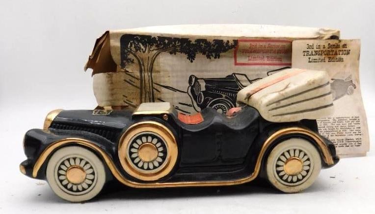 1932 Pierce-Arrow Sport Phaeton: A ceramic decanter modeled as a 1932 Pierce-Arrow Sport Phaeton in black and cream with gilt trim and spoked wheels. It is marked the third in a series on Transportation, a limited edition, and is
