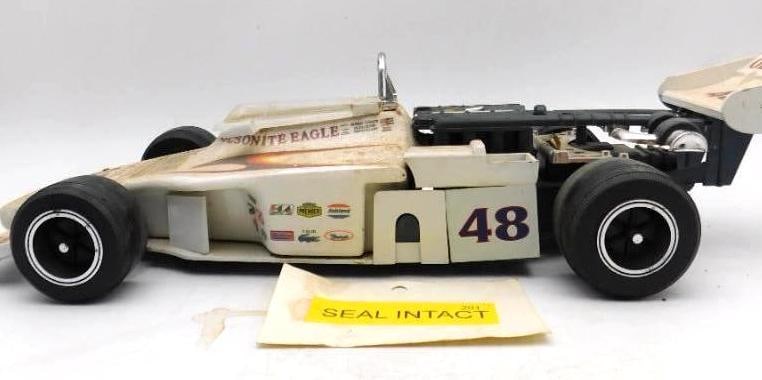 Olsonite Eagle No. 48 Indianapolis Race: A lively decanter cast as the Olsonite Eagle number 48 championship car, fitted with rubber tires, rear wing, and a full press of sponsor decals. The body panels name Bobby Unser, Ozzie Olson, and Way