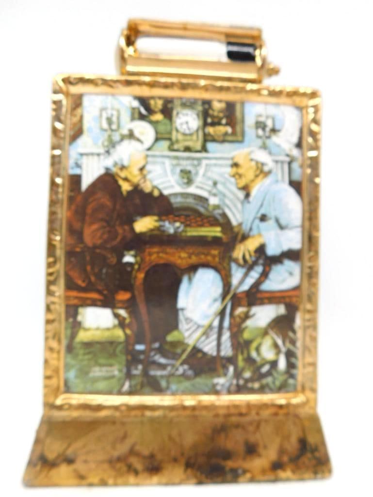 Norman Rockwell April Fools Saturday: A Norman Rockwell limited edition decanter in the form of a gilt easel frame, the face bearing the April Fools painting of two old gentlemen at checkers with all its deliberate errors for the eye to h