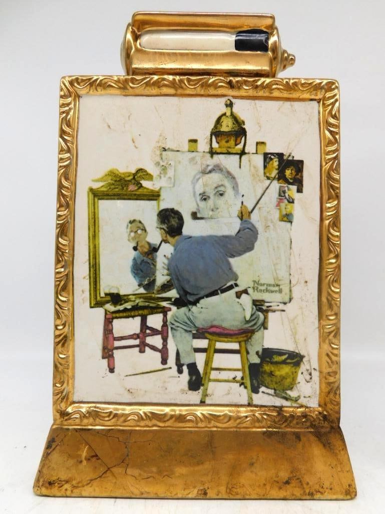 Norman Rockwell Triple Self Portrait: A ceramic decanter cast as a gilded picture frame upon a footed easel, bearing Norman Rockwell's Triple Self Portrait from the Saturday Evening Post of February 1960. The molded ornament of the frame 