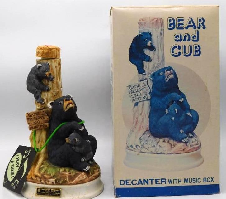 Hoffman Orig Bear and Cub Music Box: A genial Hoffman Original decanter modeled as a black bear and her cubs at a game preserve post, one cub scrambling up the tree while another nestles at her side. The painting is warm and particular,