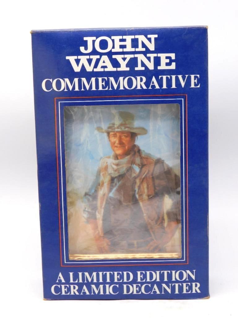 John Wayne Comm. Ltd Ed Ceramic Portrait: A handsome limited edition ceramic decanter framed in gold luster, bearing a painted portrait of John Wayne in trail coat and campaign hat. The likeness is well caught, and the gilt frame and plinth