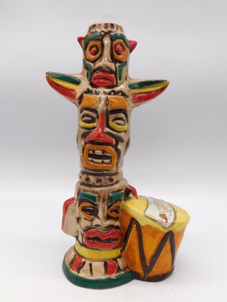 Italian Ceramic Totem Pole S. Gimignano: A ceramic wine decanter in the form of a totem pole, its stacked faces painted as bright tribal masks. Bottled by Casa Vinicola Bardi Ubaldo of Certaldo, Italy, for the S. Gimignano brand at 12