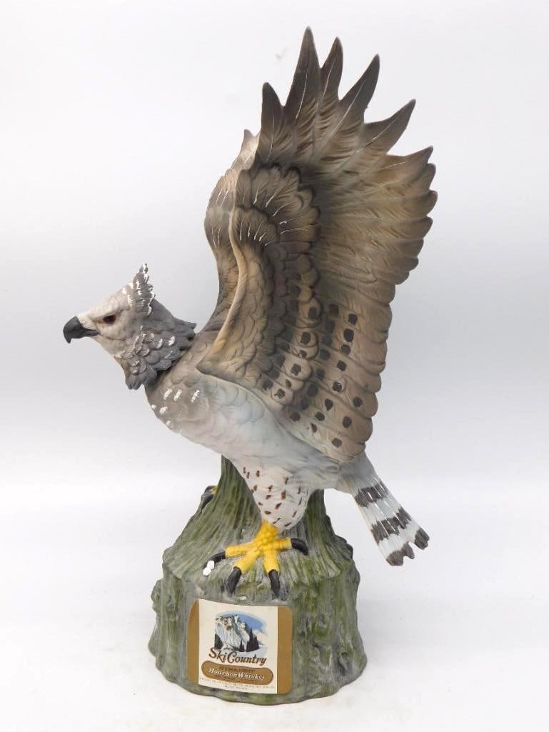 Ski Country Harpy Eagle Bird of Prey: A stately Ski Country decanter modeled as a harpy eagle mantling atop a mossy stump, wings raised and beak set against the wind. The mold-maker rendered every feather with a shrewd eye, and the