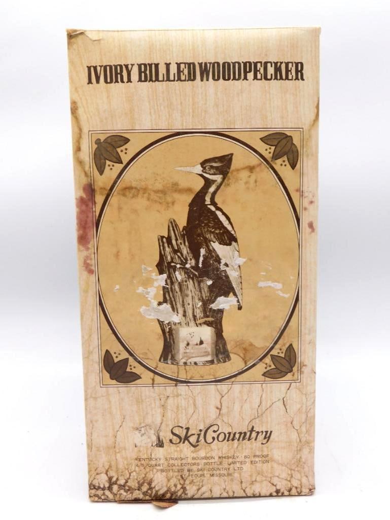 Ski Country Ivory-Billed Woodpecker: A Ski Country ceramic decanter modeled as an ivory-billed woodpecker with red crest, perched upon a tree-stump base and labeled Ski Country Kentucky Straight Bourbon Whiskey. Stands approximately 12