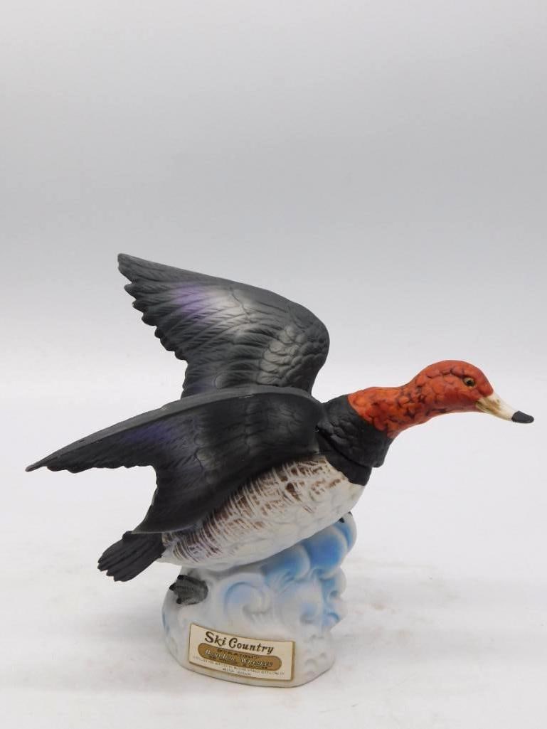 Ski Country Redhead Duck in Flight: A spirited Ski Country decanter modeled as a redhead duck rising off the water, wings spread wide and neck stretched forward. The sculptor caught the moment of lift admirably, and the painter gave