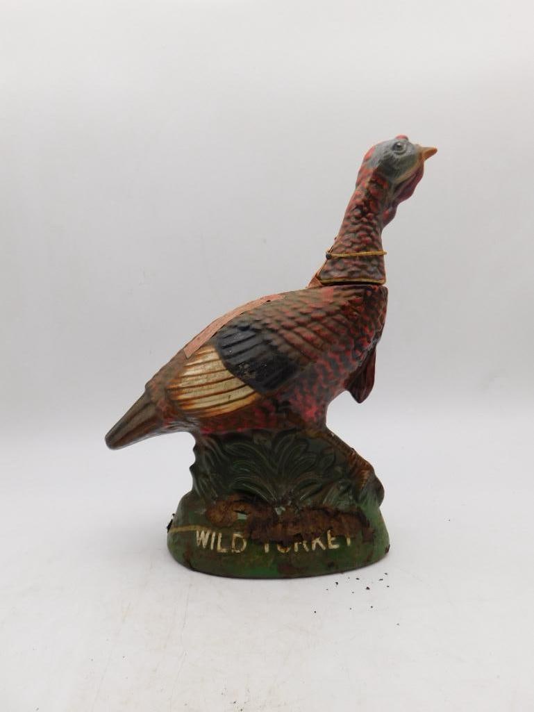 Wild Turkey No. 1 Bird Decanter, Austin: An Austin Nichols Wild Turkey ceramic decanter, hand-painted in naturalistic turkey coloring upon a grassy base, its original neck tag still hanging. A classic early entry in the long-running Wild