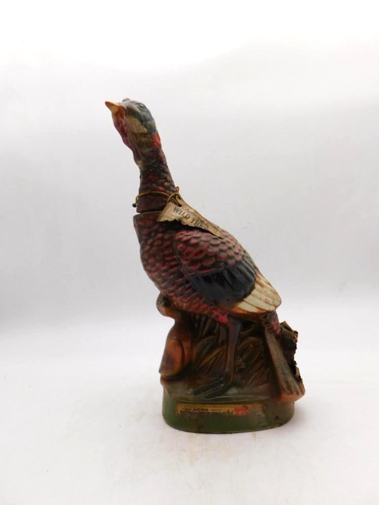 Wild Turkey Austin Nichols Bird on Stump: An Austin Nichols Wild Turkey ceramic decanter modeled as the bird perched upon a stump base, its original hang tag still attached at the neck. Good vintage order, with minor edge wear to the base.