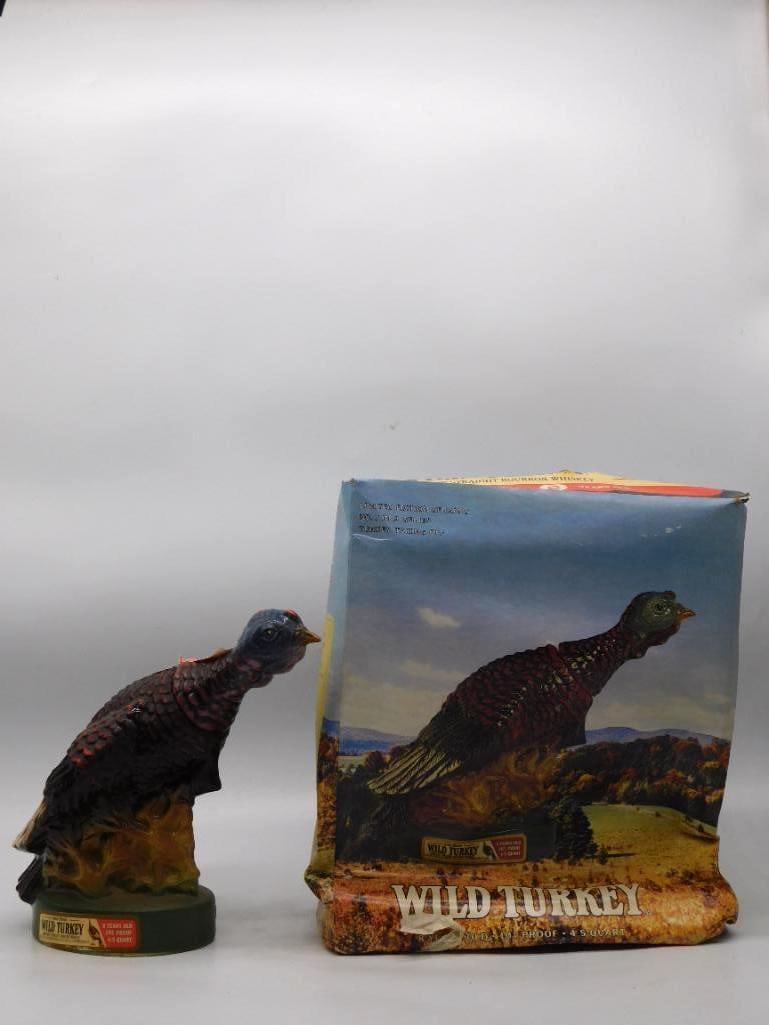 Wild Turkey Austin Nichols Standing: A lively Austin Nichols Wild Turkey decanter modeled as a tom turkey stepping out over autumn ground, head raised and neck stretched forward. The painter laid on the bronze, black, and cream of the