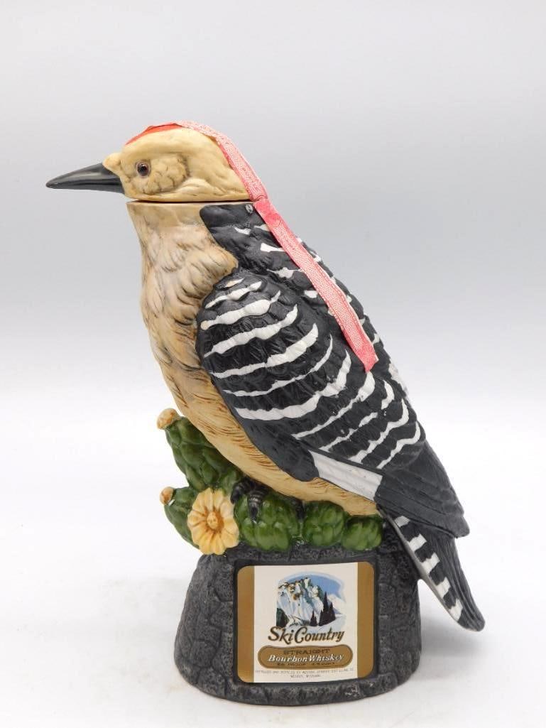 Ski Country Owl and Songbird Porcelain: A Ski Country Straight Bourbon Whiskey decanter in porcelain, sculpted as an owl paired with a yellow-breasted songbird upon a rock base. The modeling is no small feat of the mold-maker's art, and