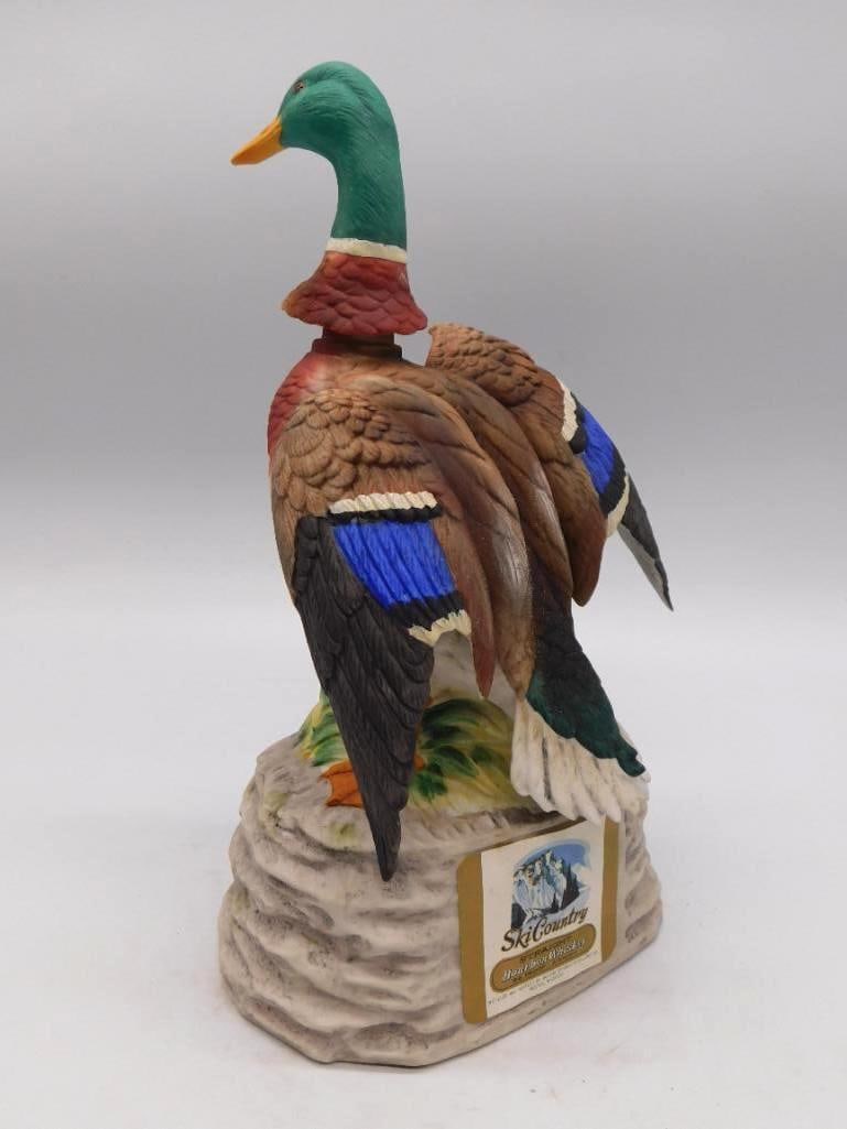 Ski Country Mallard Drake Hand-Painted: A Ski Country hand-painted porcelain decanter modeled as a standing mallard drake upon a rock base, the original paper label still to the front. Handsome color throughout, with only minor age wear. Se