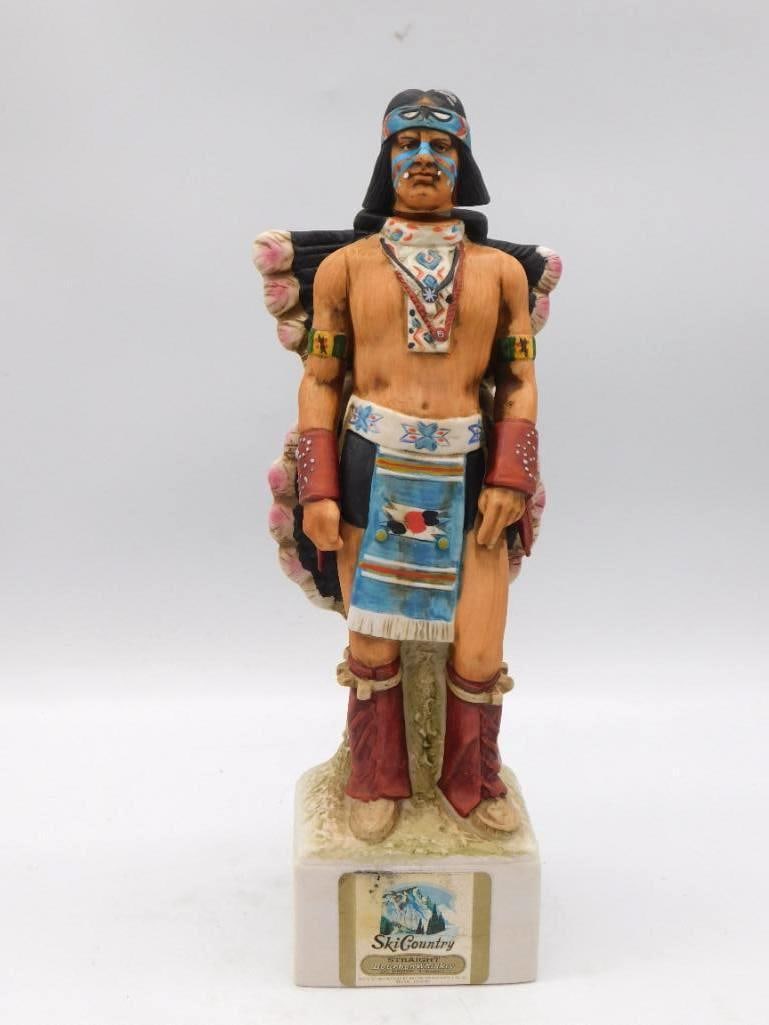 Ski Country Acoma Kachina Dancer: A Ski Country ceramic decanter rendered as a Kachina dancer in a blue mask and headdress, carrying large round shield and fan elements. A commanding piece that stands approximately 13 inches tall. The