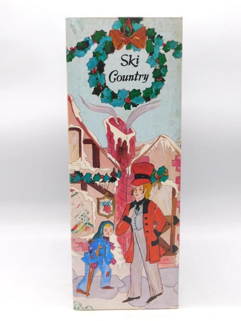 Ski Country Bob Cratchit and Tiny Tim: A Ski Country hand-painted decanter of Bob Cratchit carrying Tiny Tim, inscribed God Bless Us Every One. Presented in the original Christmas-themed box, an agreeable Dickens keepsake for the season.