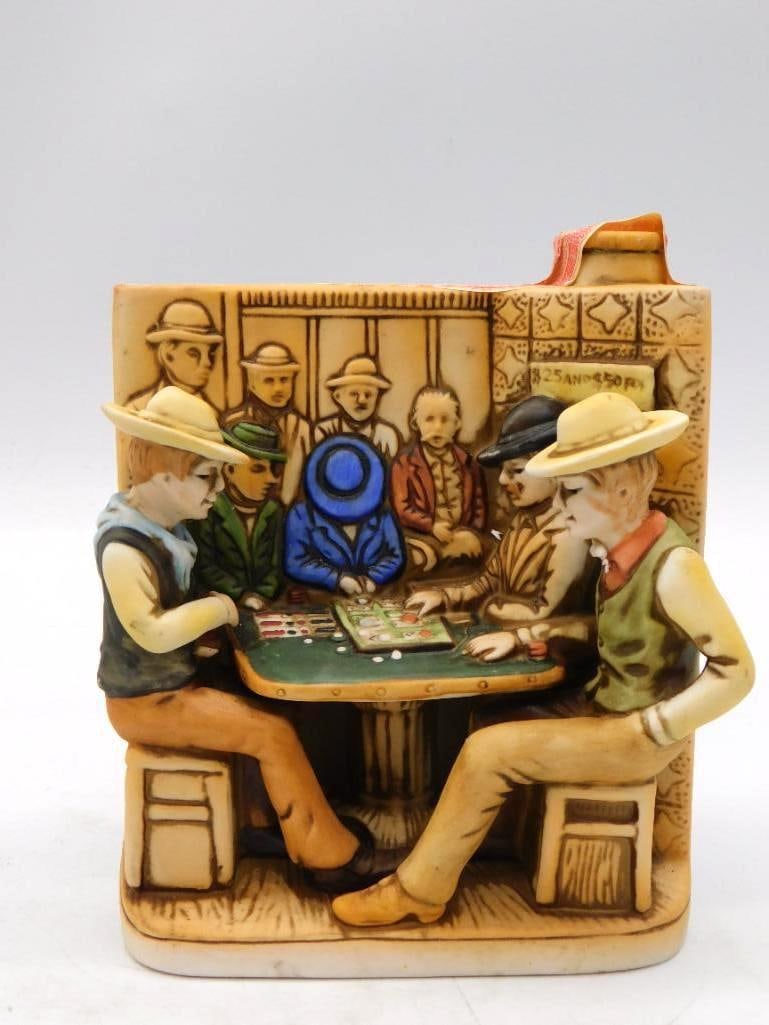 W.A. Lacey Faro Bank Old Orient Saloon: A book-shaped ceramic flask decanter carrying a raised saloon scene of a poker table in relief. The paper label reads Faro Bank at the Old Orient Saloon, Bisbee, Arizona, circa 1889, and the bottle