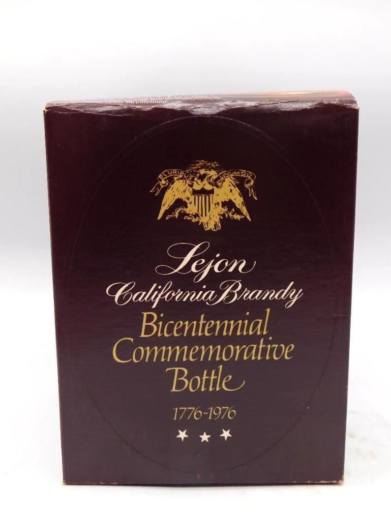 Lejon Liberty Bell 1776-1976: A Lejon California Brandy commemorative decanter cast as the Liberty Bell and dated 1776-1976, complete with its hanger and original hang tag. An earnest bit of Bicentennial Americana, and a shapely