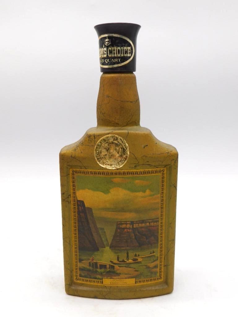 Beam's Choice Marbled Gold Sawmill Scene: A Beam's Choice ceramic decanter in a gold marbleized finish, its face set with a framed lithograph-style scene of a sawmill exhibition. Marked 86 proof and 4/5 quart. A workmanlike subject