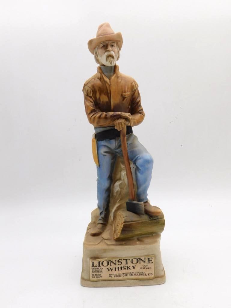 Lionstone Old West The Woodhawk Ceramic: A sturdy Lionstone decanter modeled as the Woodhawk, the frontier woodcutter who supplied cordwood to the Missouri River steamboats. He rests upon his axe in fringed shirt and denim, and the modeler g