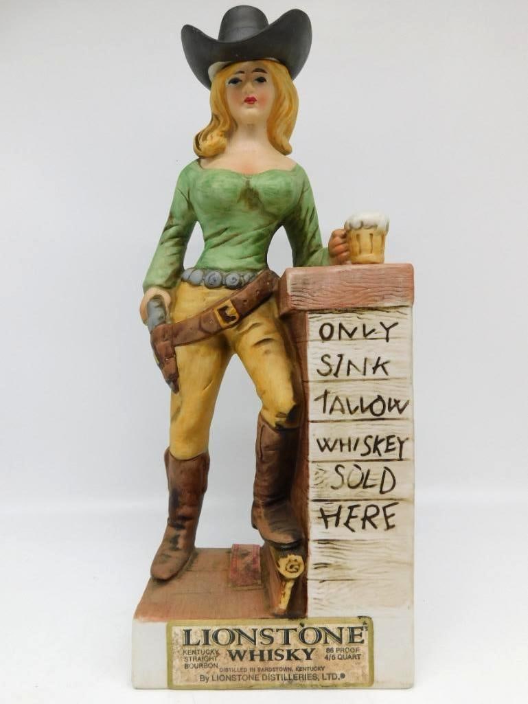Lionstone Cowgirl Decanter, Only Sink: A Lionstone Distilleries Kentucky Straight Bourbon decanter portraying a Western cowgirl with pistol and beer mug, posted beside a hand-lettered sign reading Only Sink Tallow Whiskey Sold Here.
