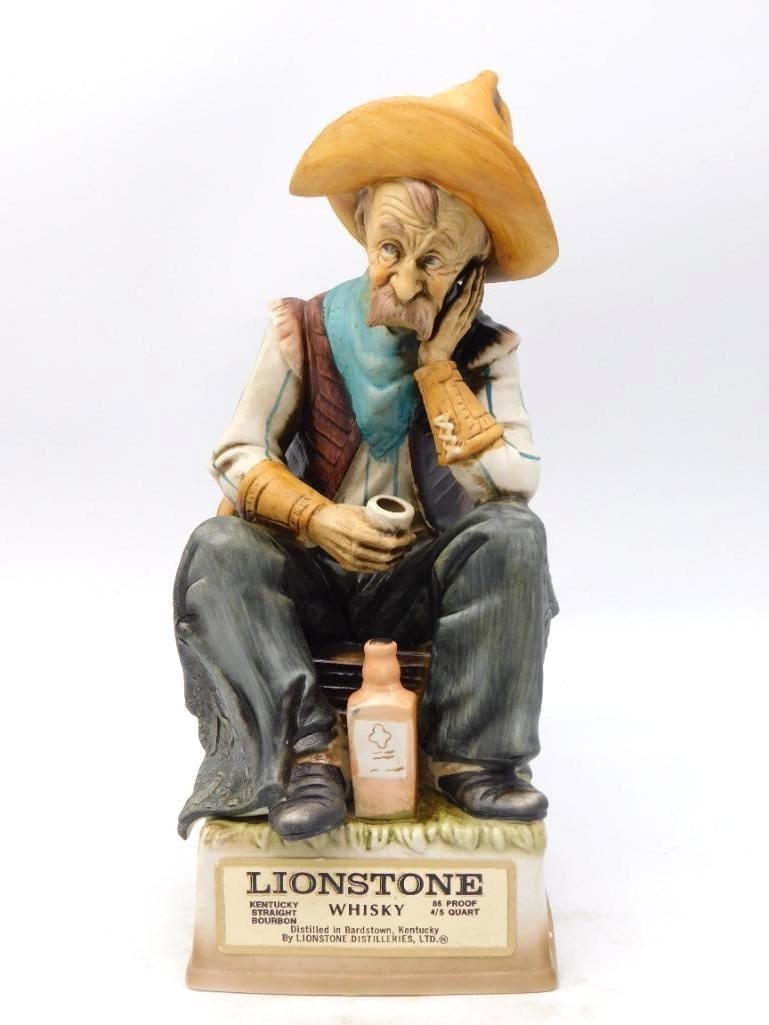 Lionstone Lonely Luke Seated Cowboy: A Lionstone bottle modeled as Lonely Luke, a trail-worn cowboy seated with his pipe in hand and his hat pushed back off a weathered face. The sculptor left nothing wanting in the whiskers and