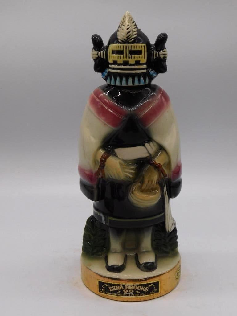 Ezra Brooks Aztec Mask Decanter: An Ezra Brooks ceramic decanter rendered as a stylized Aztec and Mayan ceremonial mask, glazed in black, red, and tan. A bold and singular subject for the shelf. Marked 90 proof Kentucky Straight