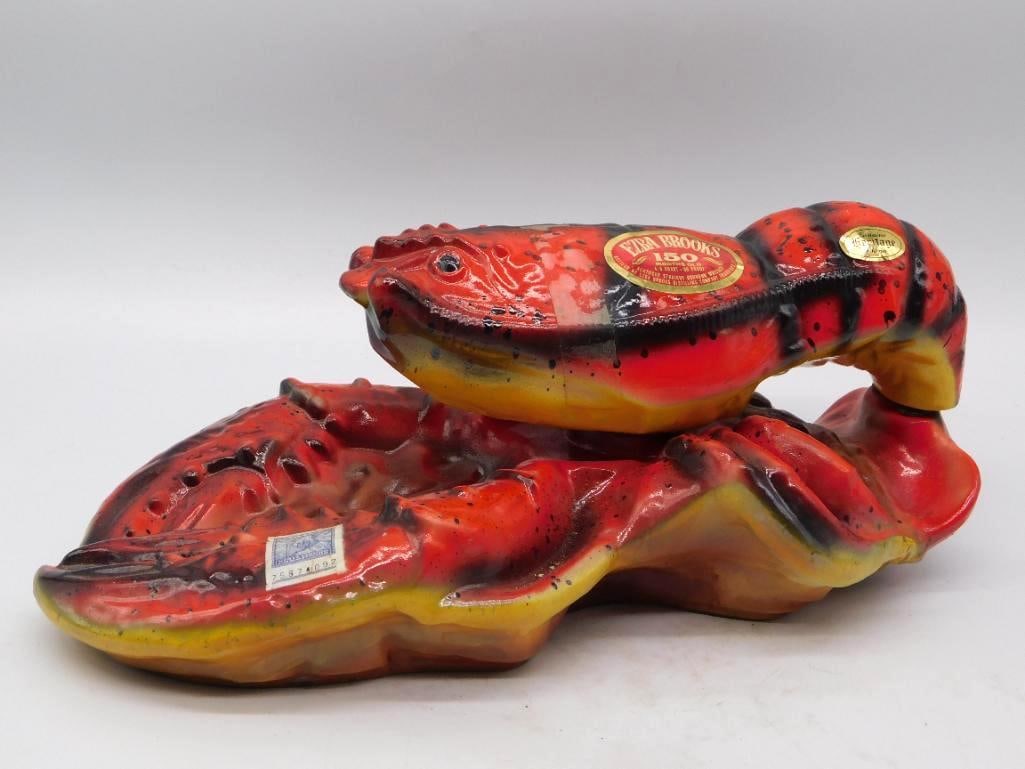 Ezra Brooks Heritage China Lobster: An uncommon Ezra Brooks decanter modeled as a lobster at rest, the shell washed in strong reds and yellows with black mottling and the claws well articulated. The upper body lifts away to serve as the