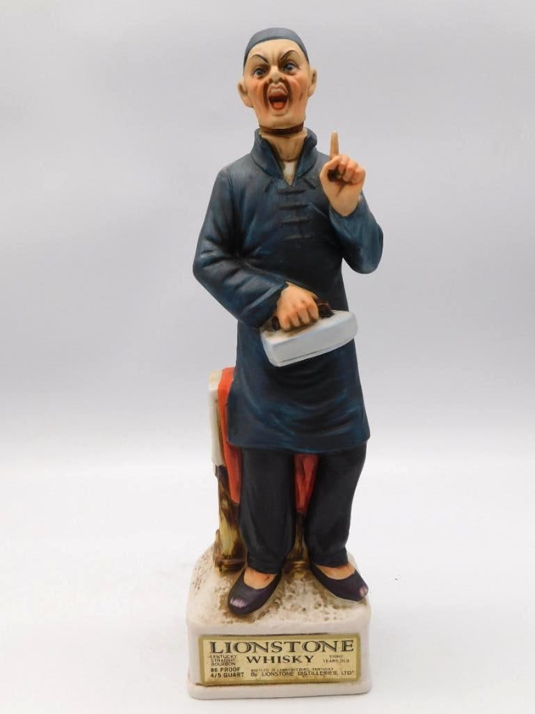 Lionstone Chinese Laundryman Decanter: A bisque porcelain decanter by Lionstone portraying a Chinese laundryman in traditional dress, a case carried at his side. The base plaque is titled Chinese Laundryman 1850-1880 and the bottle is mark