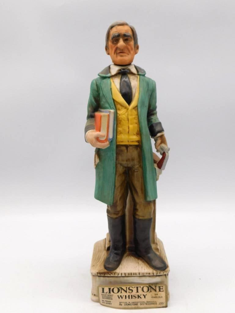 Lionstone Whiskey Circuit Riding Judge: A Lionstone bisque porcelain decanter modeled as a gentleman of the bench in a green coat, an armful of law books held close. The base plaque is titled Circuit Riding Judge 1865-1885, and the piece ca