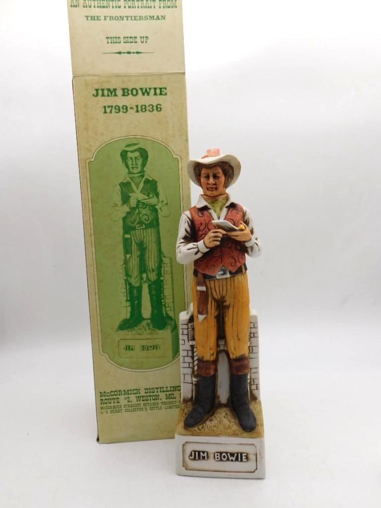McCormick Jim Bowie Frontiersman: A McCormick Distilling Americana porcelain decanter modeled as the frontiersman Jim Bowie, from The Frontiersman series, upon a pedestal base lettered Jim Bowie. The original printed cardboard