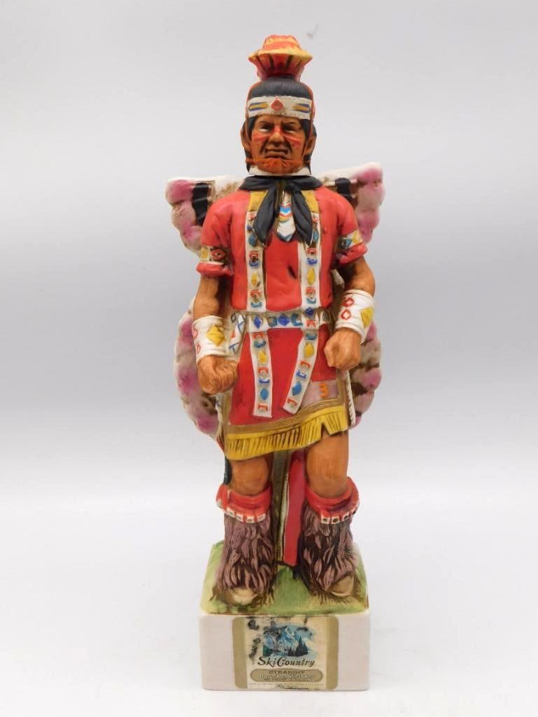 Ski Country Native American Ceremonial: A stately Ski Country Bourbon Whiskey decanter modeled as a Native American ceremonial dancer in beaded regalia with a feathered bustle. The painter did not stint on the detail of the beadwork and