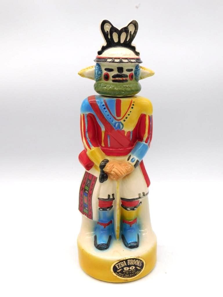 Ezra Brooks Kachina Decanter: A colorful ceramic decanter from Ezra Brooks, modeled as a Southwestern Kachina with a green face mask and a ceremonial robe painted in several colors. The mold-maker gave the figure a solemn