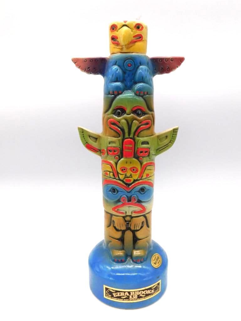 Ezra Brooks Totem Pole Decanter, Pacific: An uncommon Ezra Brooks decanter rendered as a Pacific Northwest totem pole, its stacked faces painted with eagle, bear, and mask motifs above a blue base. The carving is crisply molded and the color