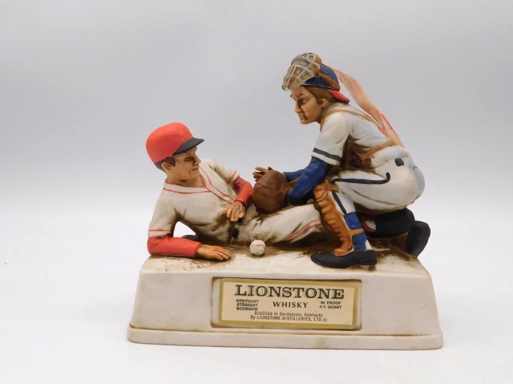 Lionstone Whiskey Baseball Players: A bisque porcelain Lionstone decanter rendered as a catcher tagging out a runner sliding into the plate, a spirited piece of sculpting and no small feat of the mold-maker's art. The base carries the