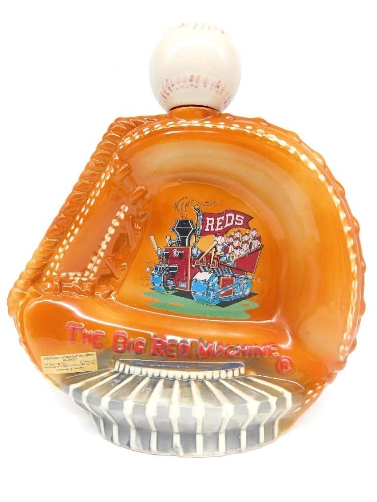 Jim Beam Cincinnati Reds Big Red Machine: A Jim Beam Regal China decanter modeled as a baseball glove for the Cincinnati Reds Big Red Machine, fitted with a baseball stopper. A second example offered in this sale. Approximately 9 inches