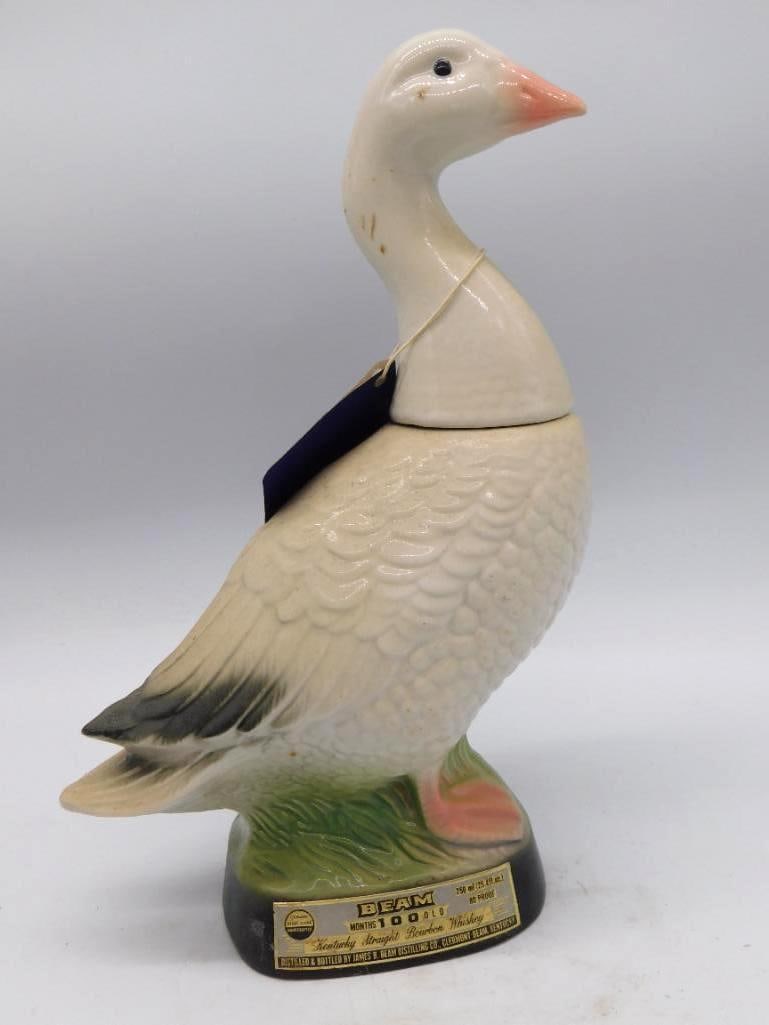 Jim Beam Canada Goose Decanter, 100: A Jim Beam 100 Months Old Kentucky Straight Bourbon Whiskey decanter in the form of a Canada goose, ceramic with hand-painted detail about the wings and neck. Approximately 14 inches long, a handsome